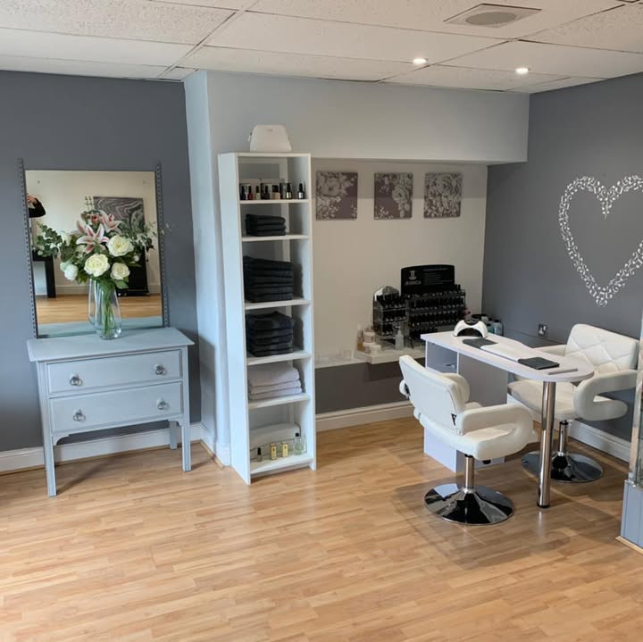 The beauty room at Snooti A Gouti, with a white nail table, grey walls and natural wood flooring